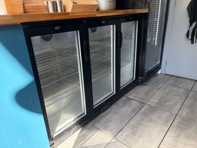 an image of a kitchen with a refrigerator and a counter