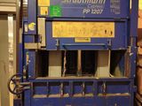 a large blue machine that is sitting in a warehouse