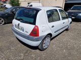a small white car that is parked in a parking lot