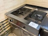 a kitchen with a sink and a stove in it