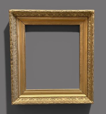an old gold frame with a shadow on a gray background
