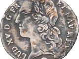 une pièce d'argent portant l'image d'une tête de femme