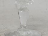a wine glass sitting on a table with a white table cloth