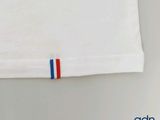 a white shirt with a red, white, and blue stripe on it