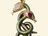 a close up of a snake with a snake head on it ' s back