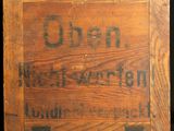 a wooden box that has a sign on it