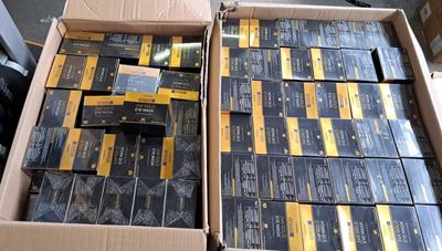 a lot of boxes of cigarettes sitting on the floor