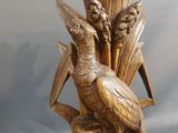 two birds that are sitting on top of a vase