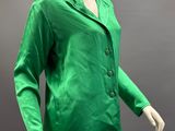 a mannequin wearing a green jacket and beige pants