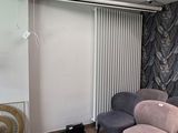 a couch and two chairs in a room with a window