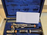 two clarinets in a case sitting on a tile floor