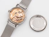 a watch that is sitting next to a watch on a table