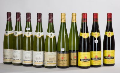 several bottles of wine are lined up on a white surface