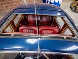 a blue car with red seats in the back of it