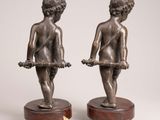 pair of antique bronze figurines of a boy and a girl