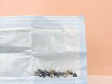 a close up of a plastic bag filled with nuts on a table
