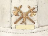 a close up of a helmet with two crossed axes on it