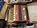 an old accordion sitting on a table next to other items