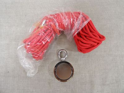 a red rope and a metal object on a table