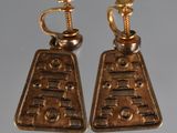 pair of gold tone earrings with screws and screws on them