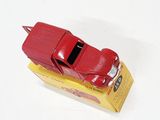 a red toy car sitting on top of a yellow box