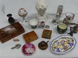 a table with a bust and a lot of items on it