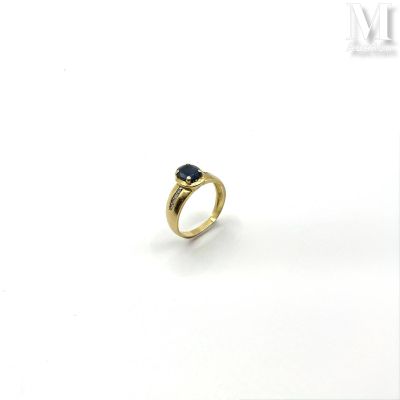 a close up of a gold ring with a sapphire stone