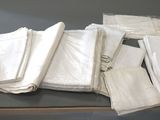 a pile of white napkins sitting on top of a table