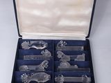 an assortment of glass figurines in a case on a white surface