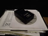 a black camera sitting on top of a pile of papers