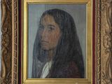 un tableau représentant une femme voilée, dans un cadre doré