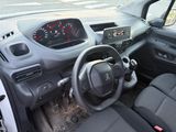 a dashboard of a small car with a clock on the dash