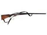 a shotgun with a wooden barrel and a black handle