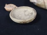 a small bowl sitting on top of a black table