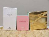three boxes of perfume sitting on top of a table next to each other