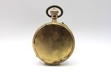 an image of a gold pocket watch sitting on a white surface