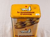 a small tin box of peanuts on a table