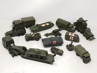a lot of toy army vehicles on a white surface