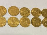 a bunch of gold coins sitting on top of a white surface
