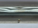 an image of a silver box with a gold ring inside of it