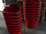 two red plastic baskets sitting on top of a wooden pallet