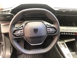 the interior of a car with a steering wheel and dashboard controls