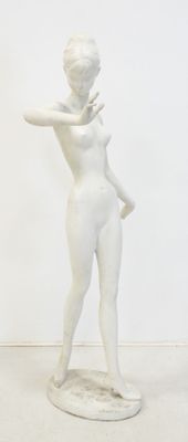 a white statue of a woman standing in a room