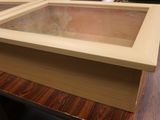 a wooden box with a glass top sitting on a table