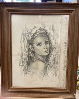 drawing of a girl in a frame on a table in front of a window