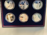 the four coin set is in a blue box on a table