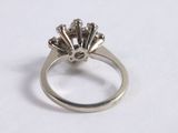 a close up of a diamond ring on a white surface