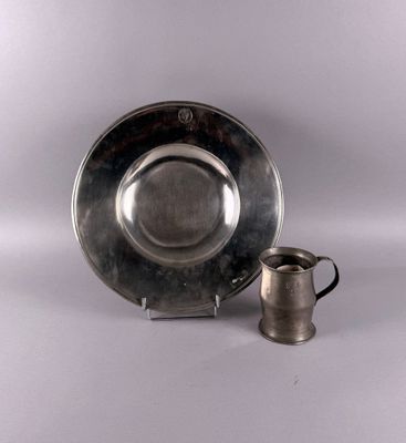 silver plate with a silver cup and saucer on a white background