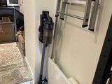 an image of a room that has a vacuum and a radiator in it