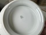 a person holding a white plate with a picture on it
